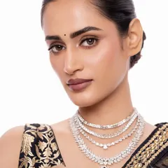 For a modern reception or cocktail event, I often suggest a sleek, layered diamond necklace. This piece, with its brilliant-cut stones and a striking emerald drop, offers a sophisticated sparkle that is both contemporary and timeless.
