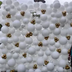 Celebrating the arrival of twins calls for something special. Here, I designed a full balloon wall using classic white with small gold clusters for an elegant and clean look, creating a beautiful backdrop for a baby shower or naming ceremony.