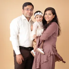 A happy family of three, smiling together. Our goal is to capture the genuine love and connection you share.