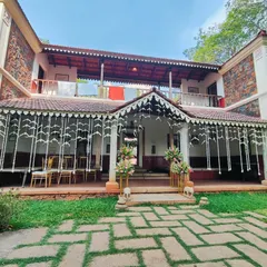 The entrance to the traditional wedding venue, decorated with hanging strings of white flowers and elegant floral bouquets.