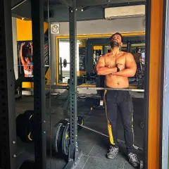 A moment of satisfaction after a tough workout. Building a strong physique is a craft that requires desire, a dream, and a clear vision.