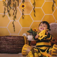 A playful moment with our little bee. The custom costume adds so much character to the photos.