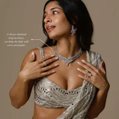 A classic diamond drop necklace catches the light with every movement, making it a stunning choice for a reception or cocktail event. Here, it is styled to perfection, showing its brilliant sparkle.