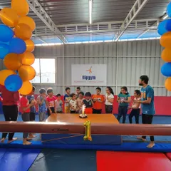 Making a wish for many more years of flips and fun. Celebrating our one-year anniversary with a cake on the balance beam.