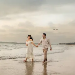A stunning wide shot of an expectant mother walking along the shoreline with her partner. Our beach maternity sessions use the beautiful natural light and scenery to create breathtaking portraits.