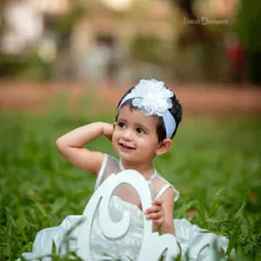 The sweetest little bundle of joy. An all-white outfit looks so angelic against the green grass.