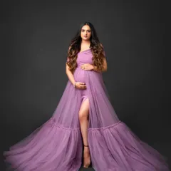 Feel radiant during your maternity shoot with our lavender gown. This studio portrait shows the dress's elegant drape and thigh-high slit, designed to beautifully highlight your baby bump.