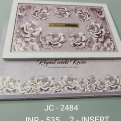 This premium invitation features a beautiful frame filled with three-dimensional lavender roses, giving it a soft and romantic feel. The gold nameplate in the center can be customized with your initials for a personal touch.