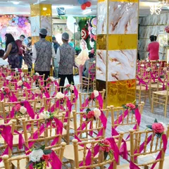 The seating arrangement in our banquet hall, with beautifully decorated chairs ready for guests to arrive for a birthday or engagement party.
