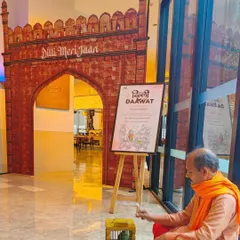 A life-sized cutout of a historic Delhi gate with "Dilli Meri Jaan" signage, creating a grand entrance for the Delhi-6 food festival. We even included live elements like a fortune-telling parrot to make the experience more interactive.