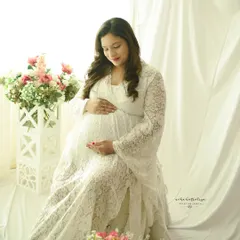 A seated portrait in the same beautiful lace gown, surrounded by flowers. This setup is perfect for a soft and feminine look.