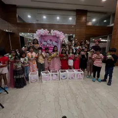 A big group photo from a fun sand art terrarium party with a Hello Kitty theme. Look at all those happy faces and their colorful creations!