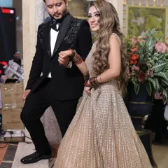 A candid moment of the couple walking hand-in-hand at their engagement party, capturing the natural flow of the event.