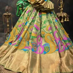 A vibrant Pen Kalamkari saree with beautifully painted swan motifs along the border. The use of bright pinks, yellows, and blues against the light green base makes this a truly joyful and artistic piece.