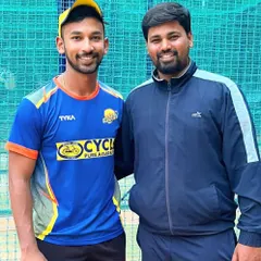One of our senior players and a coach share a moment during a training session. Mentorship is a key part of our academy's culture.