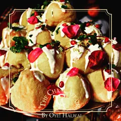 A tower of our soft, melt-in-your-mouth Dahi Bhallas. Each bhalla is soaked perfectly and topped with rich curd, sweet chutney, and garnished with fresh pomegranate and rose petals for a royal touch.