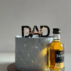 A sophisticated grey miniature cake for Father's Day, perfect for pairing with his favorite miniature bottle of whiskey.