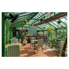 This rooftop culinary studio in Bangalore was designed as a modern Victorian conservatory. The iron and glass structure creates a light filled space for culinary events, furnished with an eclectic mix of our custom pieces.