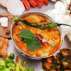 This is the heart of my vegan Gujarati thali: a bowl of creamy, spicy 'dahi tikhari' made from a soy-cashew curd. It's served with bajra roti topped with my special coconut-based vegan ghee.