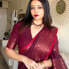 A close-up on my 'Pujor Shaaj'. The deep maroon of the cotton Benarasi is complemented by a bold red lip and traditional copper jewellery, creating a classic Bengali festive look.