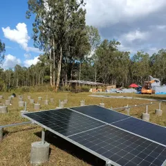 The beginning of our ground-mount solar installation for the Echoes of Earth festival. This image shows the concrete pedestals and initial panel setup for the 20kW system that powered the Big Tree Stage.