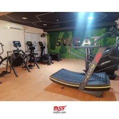 A shot of our cardio section in a commercial gym, featuring the advanced Curve Treadmill.