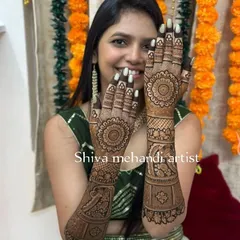 A client happily showing her mehendi, which features a large, perfectly symmetrical mandala on the back of each hand. This is a popular choice for a clean and elegant look.