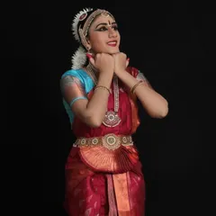 Presenting Anagha, poised and ready for her solo recital. Her costume, with its rich red and contrasting blue, was selected to create a striking presence on stage.