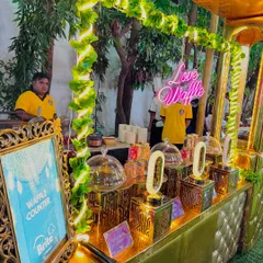 Another view of the waffle station, showcasing the elegant setup with glass cloches and crystal-style lamps.