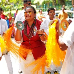 The bright sounds and colors of the procession. This woman plays the taal, or hand cymbals, her joyful expression adding to the celebratory mood of the Gudi Padwa festival.
