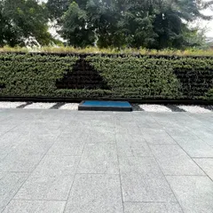 A frontal view of the patterned outdoor vertical garden, showcasing the clean lines and healthy, dense foliage. This installation is built to withstand outdoor conditions while maintaining its sophisticated aesthetic.