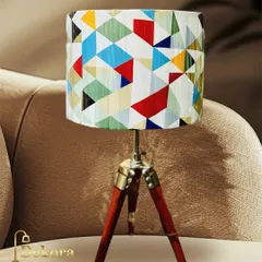 This small tripod table lamp is perfect for modern spaces where style and size matter. The colorful geometric pattern on the shade adds a playful yet chic element, making it a great accent for a side table or shelf.