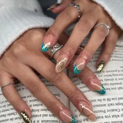 Another view of the celestial nail art set, showing how the different designs on each finger come together. This look combines negative space, bold color, and sculpted 3D elements for a cohesive story.