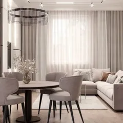 Here is a closer look at the dining area within the open-concept living space. The round table encourages conversation, while the modern upholstered chairs provide comfort. The large window with sheer curtains allows for plenty of natural light, creating a bright and inviting atmosphere for meals.