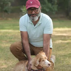 A pet parent posing with his happy dog at our party. We love seeing families enjoy our space together.