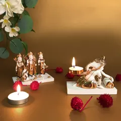 This image displays two of my smaller, elegant idol sets. On the left, a miniature Ram Darbar, and on the right, a playful Ganesha with a scroll, both crafted in white and gold porcelain for a touch of subtle divinity.