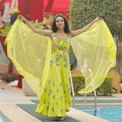 A beautiful bride ready for her mehendi ceremony in a vibrant yellow outfit. The makeup is fresh and fun, with a pop of color that perfectly suits the festive atmosphere.
