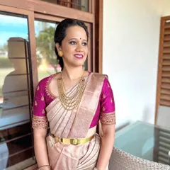 The details make the design. This is a close-up of a hand-worked raw silk blouse in a rich magenta, featuring delicate embroidery around the neckline and sleeves. It’s a versatile piece designed to elevate any silk saree.