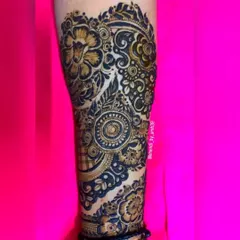 A detailed view of the henna work on the arm. This shot highlights the intricate spiral and floral motifs that make up the larger design.