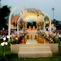 An ethereal mandap setup on a floating stage over the water, combining modern architecture with classic floral design for a truly unique wedding ceremony.
