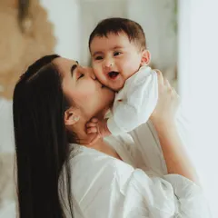 A mother's kiss and a baby's giggle. We focus on these sweet, simple interactions to create emotionally rich portraits during our family sessions.