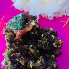 A close-up of my Aneshi chutney, made with fermented taro leaves, roasted chillies, and tomato. You can see the texture from all the pounded ingredients.