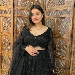 A smiling shot in this classic black lehenga. It's a versatile piece that guarantees you'll be the star of the party.