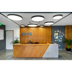 The reception area for Atlantis in Noida sets a professional and welcoming tone. My general contracting team ensured a flawless execution of the design, from the slatted wood paneling and geometric desk to the integrated halo lighting, creating a strong first impression.