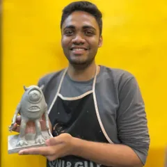 Student Raheel proudly presents his finished clay sculpture of Mike Wazowski. Our classes guide you through the process of transforming a simple lump of clay into a detailed and expressive character.