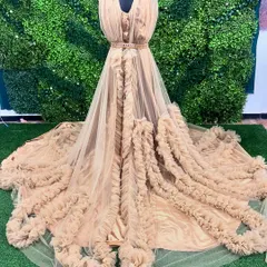 This stunning beige ruffle gown is one of the unique designer pieces in my collection. The intricate ruffles and long train make it a true statement piece.