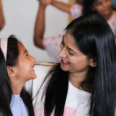 A quiet, happy moment shared between a mother and daughter. It's these small connections that build our strong and supportive community.