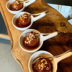 Our Gulab Jamuns are soft, syrupy, and incredibly delicious. We serve them in elegant, individual portions, garnished with chopped nuts for an added crunch.