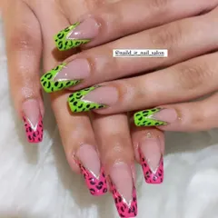 A bold and playful design featuring hand-painted animal print. This look combines neon green and hot pink leopard print in a modern V-shaped French style.