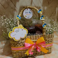 Another beautiful Kauna grass basket, filled with goodies and decorated with baby's breath and custom tags for a first birthday.